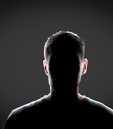 a dark backlight shadow silhouette of male person, incognito unknown profile